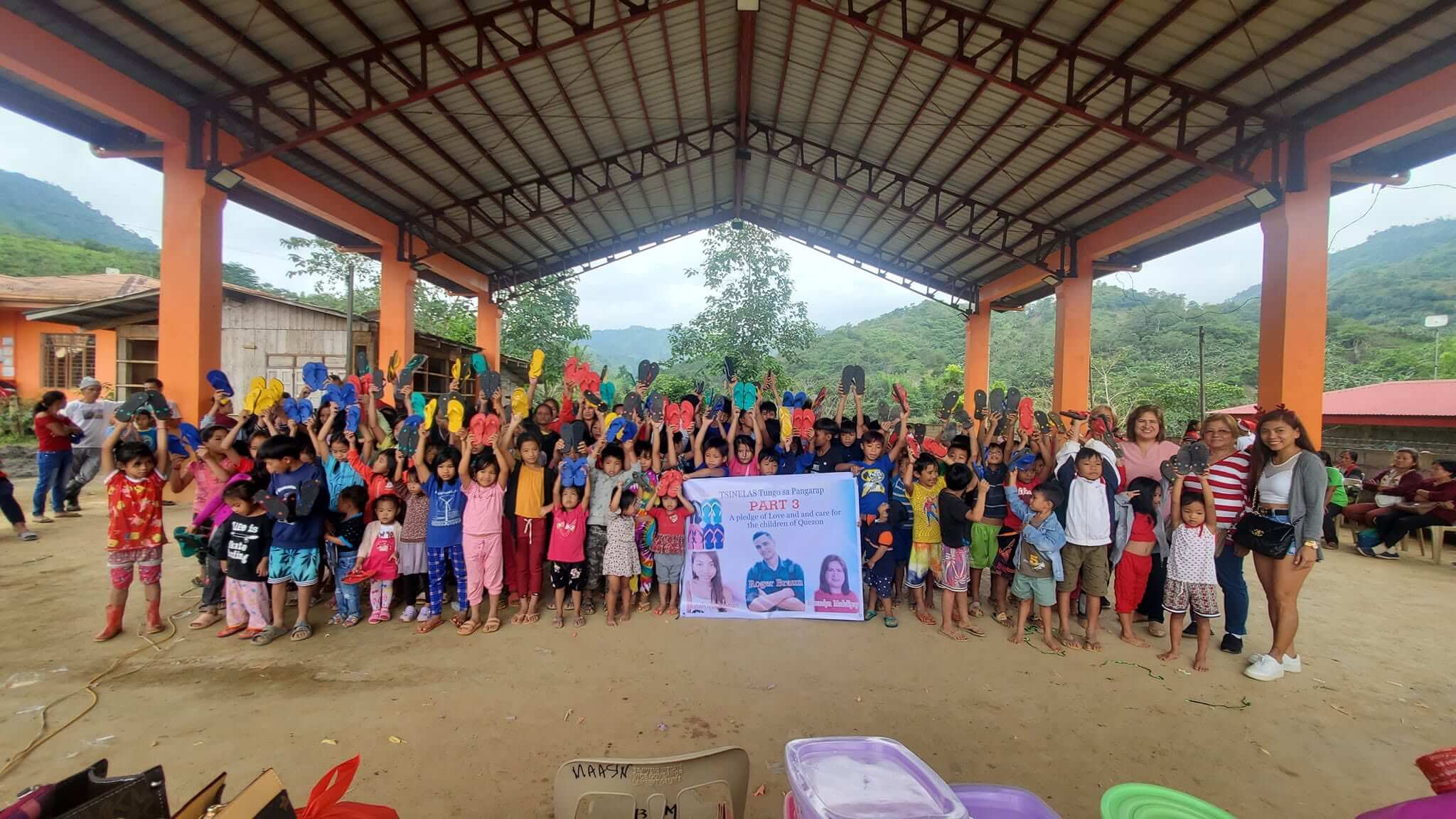 Community members celebrating at the Tsinelas Tungo sa Pangarap slippers distribution in Barangay Maasin, Quezon, Nueva Vizcaya